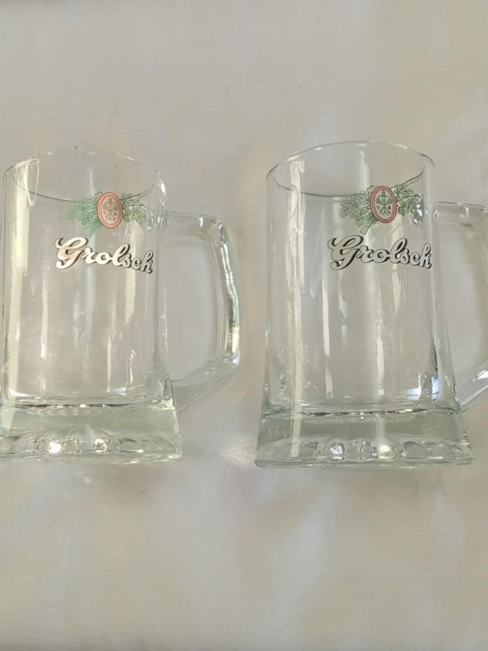 Two vintage Grolsch beer mugs or glasss with the brewery's logo